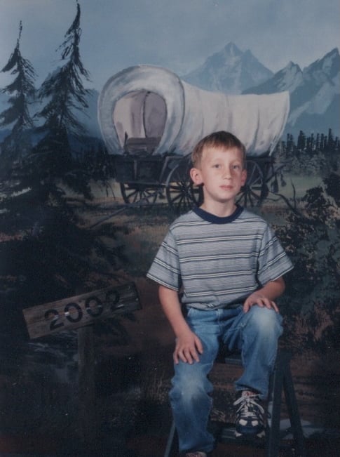 My photograph in front of a covered wagon.