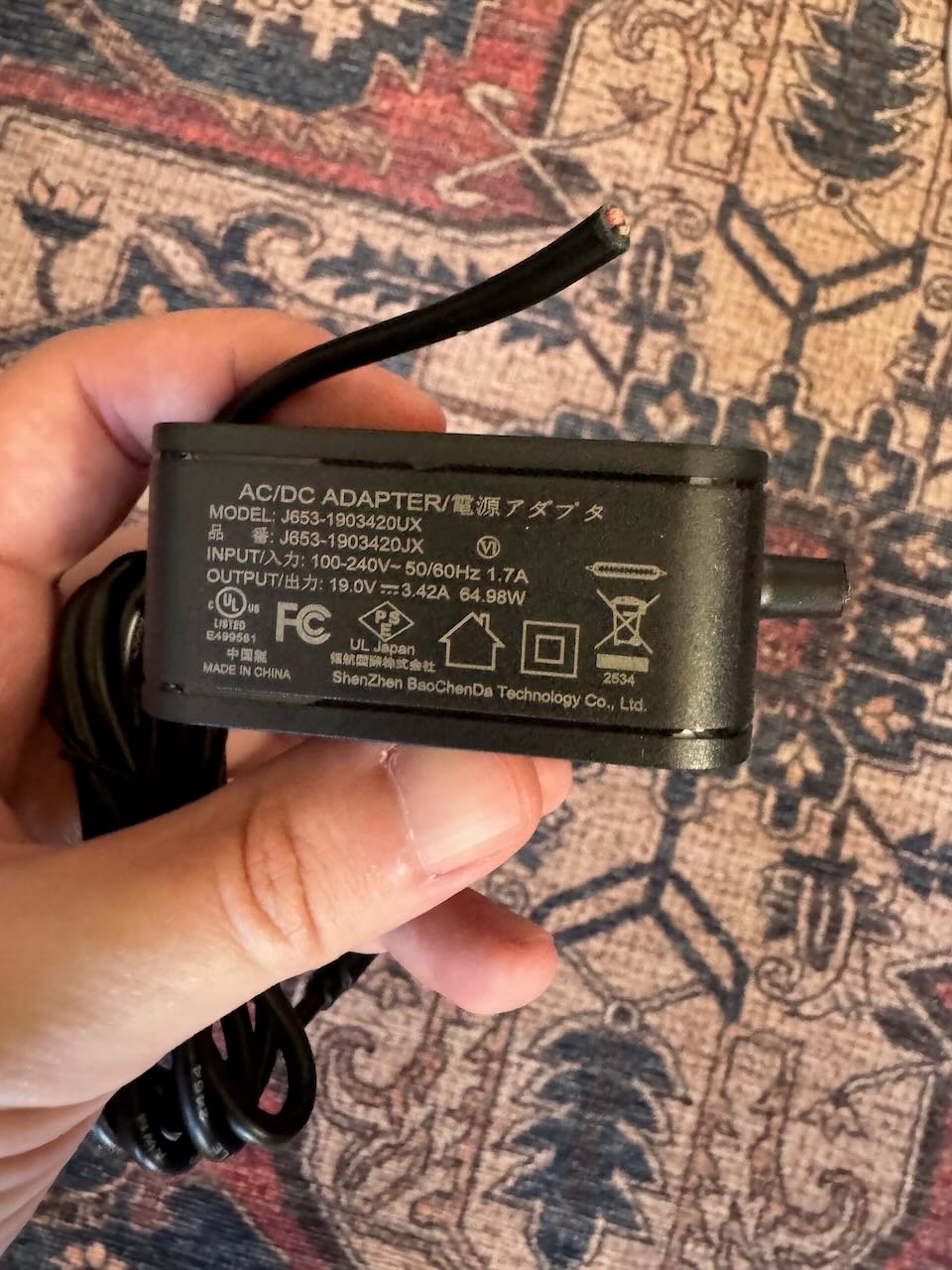 the sketchy power adapter with it's cable cut